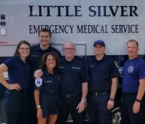 Freehold EMS Squad Chief Jeff Hoffman (fourth from left) stands with a few of the responders who helped save his life. (Photo/EMSCNJ)