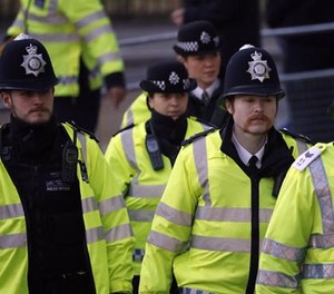 Police officers arrive at the Supreme Court in London, Monday, Dec. 5, 2016.