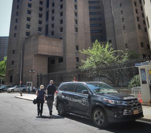 New York City medical examiner personnel leave their vehicle and walk to the Manhattan Correctional Center where financier Jeffrey Epstein died by suicide while awaiting trial on sex-trafficking charges, Saturday Aug. 10, 2019, in New York. (AP Photo/Bebeto Matthews)