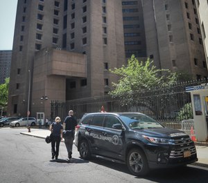 New York City medical examiner personnel leave their vehicle and walk to the Manhattan Correctional Center where financier Jeffrey Epstein died by suicide while awaiting trial on sex-trafficking charges, Saturday Aug. 10, 2019, in New York.