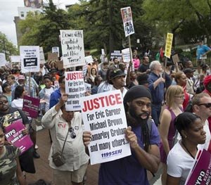 Demonstrators march to protest the death of Eric Garner, Saturday, Aug. 23, 2014, in the Staten Island borough of New York.