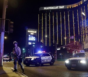 Police officers stand along the Las Vegas Strip the Mandalay Bay resort and casino during a shooting near the casino, Sunday, Oct. 1, 2017, in Las Vegas.