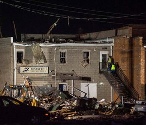 Emergency personnel investigate the damage done from an explosion to Advanced Rehab and Sports Medicine in Canton, Ill. (Lewis Marien/The Journal-Star via AP)