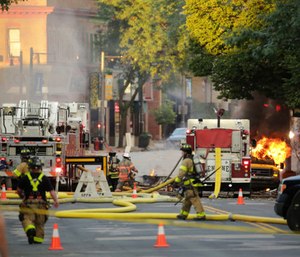 A firefighter was killed and at least a dozen other people were injured when a natural gas explosion leveled at least two buildings.
