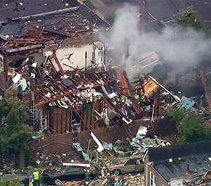 Emergency service personnel work at the scene of a house explosion, Tuesday, Sept. 27, 2016, in the Bronx borough of New York.