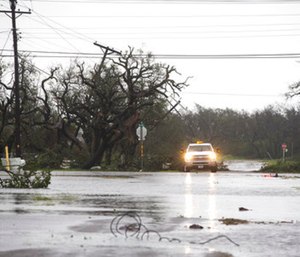 A vehicle drives through flooded roads after Hurricane Harvey ripped through Rockport, Texas, on Saturday, Aug. 26, 2017.