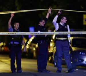 In this Sept. 2, 2017, file photo, police lift crime scene tape after two people were shot and transported to Stroger Hospital in Chicago.