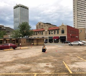 An investigator collects evidence near an Arkansas nightclub where police say multiple people were shot, Saturday, July 1, 2017, in Little Rock, Ark. (AP Photo/Andrew DeMillo)
