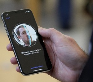 In this Friday, Nov. 3, 2017, file photo, an Apple employee demonstrates the facial recognition feature of the new iPhone X at the Apple Union Square store in San Francisco. (AP Photo/Eric Risberg, File)
