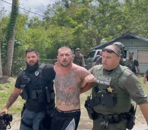 Video shows Ryan Lee Pope was shirtless and shoeless as U.S. Marshals led him from a single-family home.