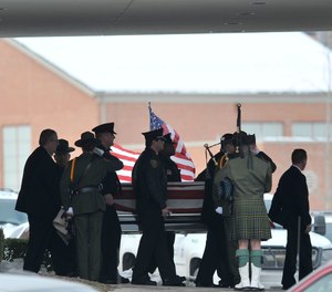In this Dec. 22, 2010, file photo, law enforcement officers carry the casket of Border Patrol officer and former U.S. Marine Brian Terry out of Greater Grace Temple after his funeral service in Detroit. (John T. Greilick/Detroit News via AP, File)
