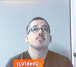 In this Dec. 7, 2016 photo, Ruben Hernandez, an FBI agent, appears via video screen from Kent County Jail in Grand Rapids, Mich. (Kent County Courthouse/MLive.com-The Grand Rapids Press via AP)