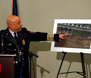 Ted Poszywak, chief of the Frederick-Firestone fire department, points at a picture during a news conference, of the location where an unrefined gas leak explosion killed two people inside their home, in Firestone, Colo. (AP Photo/Brennan Linsley)