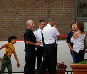 Fire officers talk to residents outside Burnham block, part of the Chalcots Estate in the borough of Camden, after the local council evacuated some 650 homes overnight. (AP Photo/Alastair Grant)