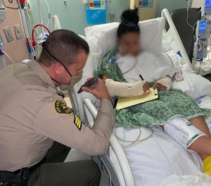 In this photo shared September 19, 2020, an LA County deputy, who has only been identified as a 31-year-old mother, takes a phone call from President Trump in her hospital bed.