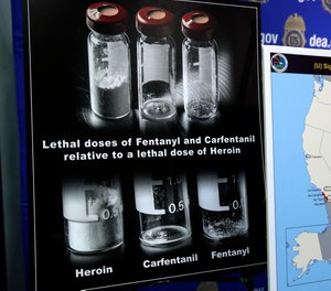 Posters comparing lethal amounts of heroin, fentanyl, and carfentanil, are on display during a news conference about the dangers of fentanyl, at DEA Headquarters in Arlington Va., Tuesday, June 6, 2017.