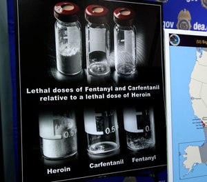 Posters comparing lethal amounts of heroin, fentanyl, and carfentanil, are on display during a news conference about the dangers of fentanyl, at DEA Headquarters in Arlington Va., Tuesday, June 6, 2017.