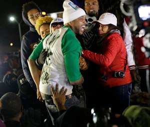 Lesley McSpadden, the mother of Michael Brown, wearing sunglasses, reacts as she listens to the announcement of the grand jury decision Monday, Nov. 24, 2014, in Ferguson, Mo. A grand jury has decided not to indict Ferguson police officer Darren Wilson in the death of Michael Brown, the unarmed, black 18-year-old whose fatal shooting sparked sometimes violent protests. (AP Photo/Charlie Riedel)