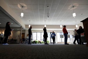 Voters in line for Illinois primary election ballots keep their distance on March 17. Image: AP Photo/Nam Y. Huh