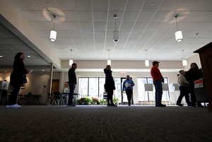 Voters in line for Illinois primary election ballots keep their distance on March 17. Image: AP Photo/Nam Y. Huh