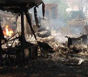 This photo shows a home where authorities said a gunman set his house on fire and fatally shot the first deputy who arrived Saturday, Nov. 22, 2014 in Tallahasse, Fla.