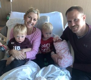 Newborn girl Camryn met her older twin brothers at the hospital after her firefighter father assisted in her roadside delivery. (Photo/Orange County Fire Authority Facebook)