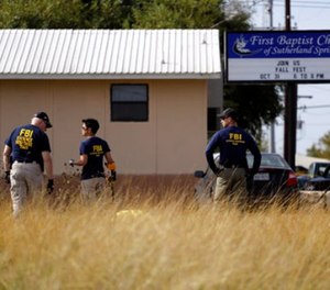 Law enforcement officials investigate the scene of a shooting at the First Baptist Church of Sutherland Springs, Monday, Nov. 6, 2017, in Sutherland Springs, Texas.