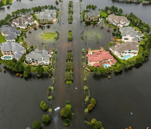Floodwaters fill the road running through the Lakes On Eldridge North subdivision in the aftermath of Tropical Storm Harvey.