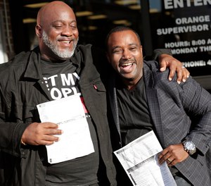 Former felons Desmond Meade, president of the Florida Rights Restoration Coalition, left, and David Ayala, husband of State Attorney Aramis Ayala, celebrate with copies of their voter registration forms after they registered at the Supervisor of Elections office Tuesday, Jan. 8, 2019, in Orlando, Fla. Former felons in Florida began registering for elections on Tuesday, when an amendment that restores their voting rights went into effect.