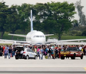 People stand on the tarmac at the Fort Lauderdale-Hollywood International Airport after a shooter opened fire inside a terminal of the airport. (AP Photo/Lynne Sladky)