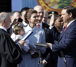 Ron DeSantis, right, is sworn in as Florida Governor by Chief Justice Charles Canady, left, as his wife Casey and son Mason look on, Tuesday, Jan. 8, 2019, in Tallahassee, Fla. Republicans will begin their third decade dominating the state's Capitol. At center is former Gov. Rick Scott. (AP Photo/Lynne Sladky)