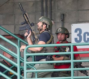 Law enforcement personnel search a garage area at Fort Lauderdale–Hollywood International Airport, Friday, Jan. 6, 2017, in Fort Lauderdale, Fla.