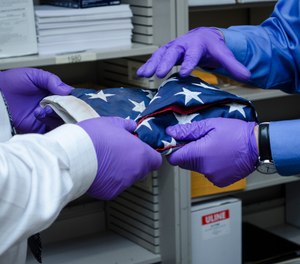 Detectives enlisted the help of Washington State Patrol Forensic Scientist William Schneck to examine particulate debris on the flag and compare it with known debris samples collected at the World Trade Center shortly after the terrorist attacks.