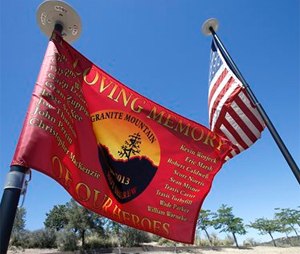 Flags fly at a memorial gravesite at Pioneer Cemetery where the 19 Granite Mountain Hotshots are honored.