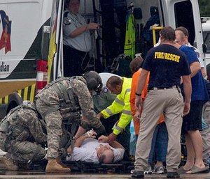 Emergency responders and medics prepare a patient for an air evacuation after he was rescued from rising floodwater near Walker, La., after heavy rains inundated the region, Sunday, Aug. 14, 2016.