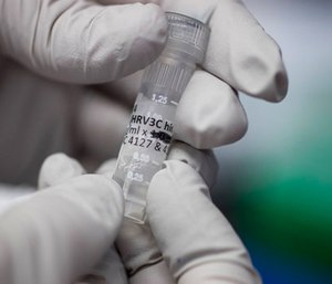 Biologist Rebecca Gillespie holds a vial of flu-fighting antibodies at the Vaccine Research Center at the National Institutes of Health.