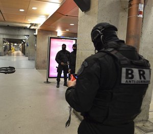 A member of the Research and Intervention Brigades (BRI) controls a drone during a terror attack exercise at the Gare Montparnasse railway station in Paris, Wednesday, April 20, 2016.