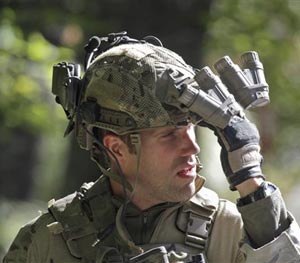An FBI agent with combat gear and night vision optics exits a wooded area at Buck Hill Falls in Barrett Township, P., where the search for Eric Frein continues Friday Sept. 26, 2014.