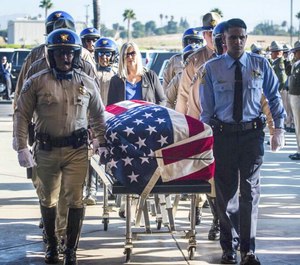 In this August 20, 2019 file photo, the flag-draped casket of fallen California Highway Patrol Officer Andre Moye Jr. arrives at Harvest Christian Fellowship church in Riverside, Calif. (Photo/TNS)