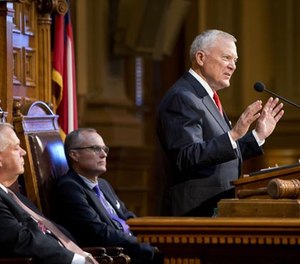 Georgia Gov. Nathan Deal, right, delivers his State of the State address on the House floor as House Speaker David Ralston, left, and Lt. Gov. Casey Cagle look on at the Capitol Wednesday, Jan. 13, 2016, in Atlanta.