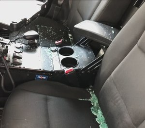 Three people have been arrested under suspicion of tossing Molotov cocktails at patrol cars as they were parked outside officers' homes.