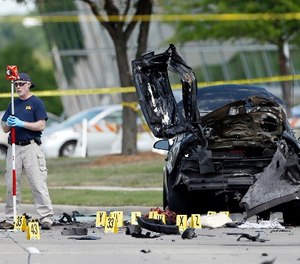 In this May 4, 2015 file photo, FBI crime scene investigators document evidence outside the Curtis Culwell Center in Garland, Texas.