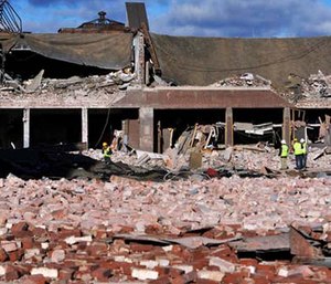 Inspectors assess damage around the area of a gas explosion that leveled a strip club in Springfield, Mass., on Nov. 23, 2012. (AP Photo/Jessica Hill, File)