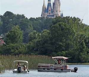 Officials search for the body of the toddler at the Seven Seas Lagoon.