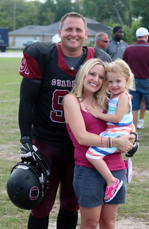 Sgt. Christopher Gavette pictured with his wife and daughter after a National Public Safety Football League (NPSFL) game. Gavette credits much of his leadership skills to growing up on sports teams.