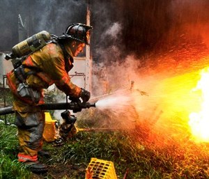 Army Pvt. 1st Class Lucas Ternell puts out a small debris fire in a yard in Salisbury, Md. (Photo/Wikimedia Commons)