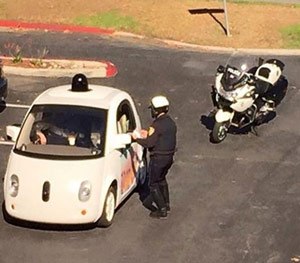 An officer pulling over the Google car.