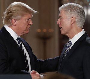 President Donald Trump shakes hands with 10th U.S. Circuit Court of Appeals Judge Neil Gorsuch, his choice for Supreme Court associate justice in the East Room of the White House in Washington, Tuesday, Jan. 31, 2017. (AP Photo/Carolyn Kaster)