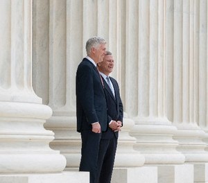 In this photo provided by the Supreme Court new Supreme Court Justice Neil Gorsuch, left, stands with Chief Justice John Roberts outside the court in Washington, Thursday, June 15, 2017, following Gorsuch formal investiture ceremony of Associate Justice.