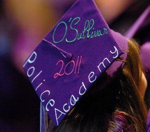 Tara O'Sullivan decorated her mortar board with her police academy plans at College Park High School's commencement ceremony in Concord, Calif. (Karl Mondon/Bay Area News Group via AP, File)